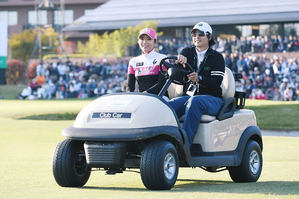 Bo-Mee Lee of South Korea smiles in golf cart as she is driven to the 18th tee for a playoff during the final round of the Itoen Ladies Golf Tournament 2016 at the Great Island Club